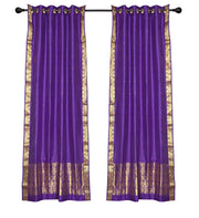Purple sari ring top curtains hung at a window