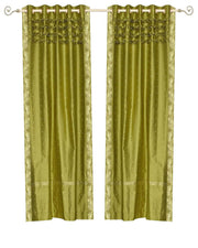 Olive green sari grommet top curtains hung at a window