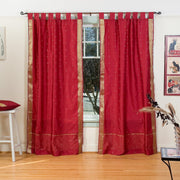 Maroon sari tab top curtains hung at a window
