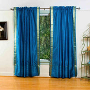 Turquoise sari rod pocket curtains hung at a window