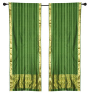 Green sari rod pocket curtains hung at a window