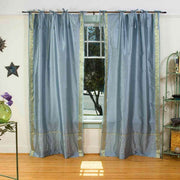 Gray sari tie top curtains hung at a window