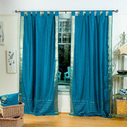 Turquoise sari tab top curtains hung at a window