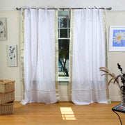 White sari tie top curtains hung at a window