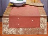 Rust silk table runner running down a dining table