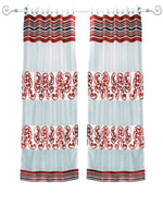 Maroon sheer tissue ring top curtains hung at a window