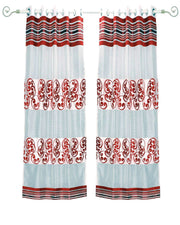 Maroon sheer tissue ring top curtains hung at a window