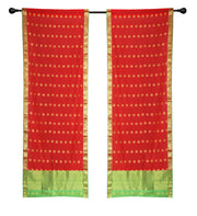 Red sari rod pocket curtains hung at a window