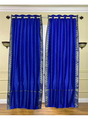 Blue sari grommet top curtains hung at a window