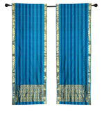 Blue sari rod pocket curtains hung at a window