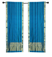 Blue sari rod pocket curtains hung at a window