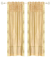 Golden sari grommet top curtains hung at a window
