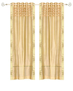 Golden sari grommet top curtains hung at a window