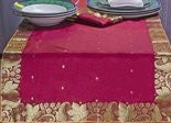Maroon silk table runner running down a dining table