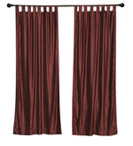 Wine velvet tab top curtains hung at a window