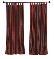 Wine velvet tab top curtains hung at a window