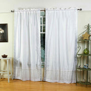 Silver sari rod pocket curtains hung at a window