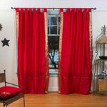 Fire brick sari tab top curtains hung at a window