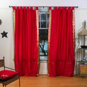 Fire brick sari tab top curtains hung at a window