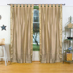 Golden sari tab top curtains hung at a window