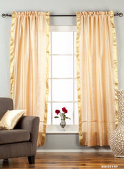 Misty rose sari rod pocket curtains hung at a window