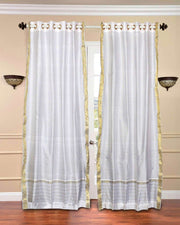 White sari grommet top curtains hung at a window