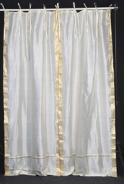 Cream sari tie top curtains hung at a window