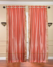 Peach sari grommet top curtains hung at a window