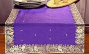 Regal purple silk table runner running down a dining table