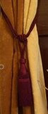 Maroon sari curtain tiebacks holding a panel open