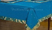 Turquoise sari tablecloth laid on a dining table