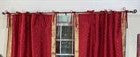 Maroon sari tie top curtains hung at a window