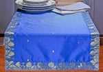 Blue silk table runner running down a dining table