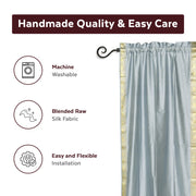Gray sari rod pocket curtains hung at a window