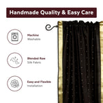 Black sari rod pocket curtains hung at a window