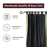 Black sari tab top curtains hung at a window
