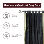 Black sari tab top curtains hung at a window