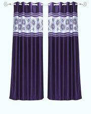 Purple sari grommet top curtains hung at a window