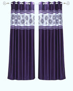 Purple sari grommet top curtains hung at a window