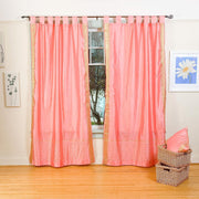 Pink sari tab top curtains hung at a window