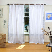 Silver sari tie top curtains hung at a window
