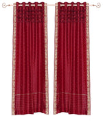 Fire brick sari grommet top curtains hung at a window