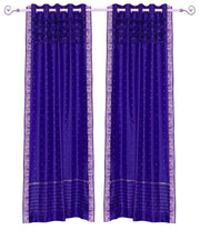 Purple sari grommet top curtains hung at a window