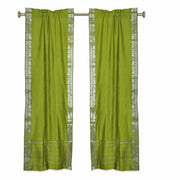 Olive green sari rod pocket curtains hung at a window