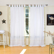 White sari tab top curtains hung at a window