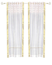 White sari grommet top curtains hung at a window