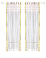 White sari grommet top curtains hung at a window