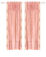 Peach sari grommet top curtains hung at a window