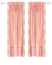 Peach sari grommet top curtains hung at a window