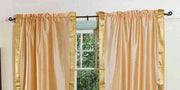 Gold sari rod pocket curtains hung at a window